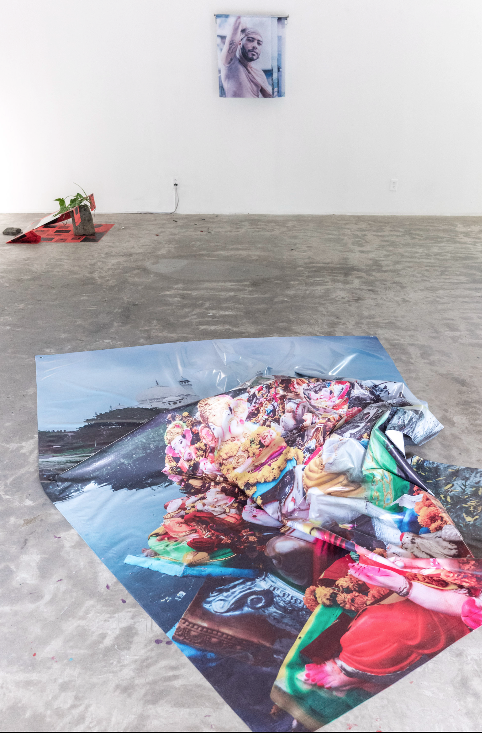 Floor sculpture — archival inkjet on polyester tarp, photographed behind the Taj Mahal at the end of Ganesh Chaturthi, statues of the deity left behind