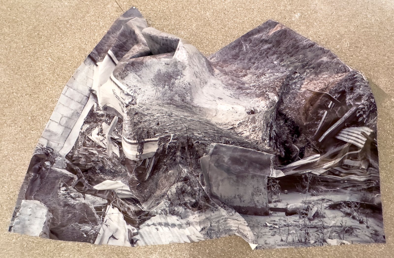 The landslide — archival inkjet on polyester tarp, held up by cinder blocks representing the material of Queja's homes and the strength of the slide that destroyed them