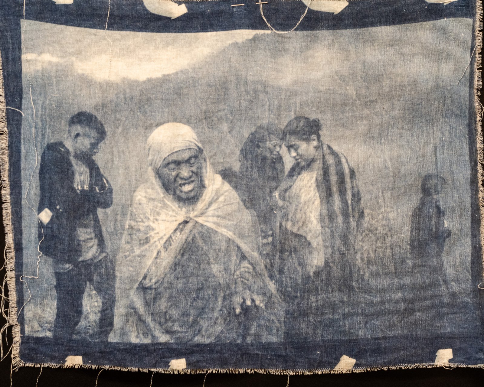 Elderly woman in shawl with children behind — cyanotype on cotton