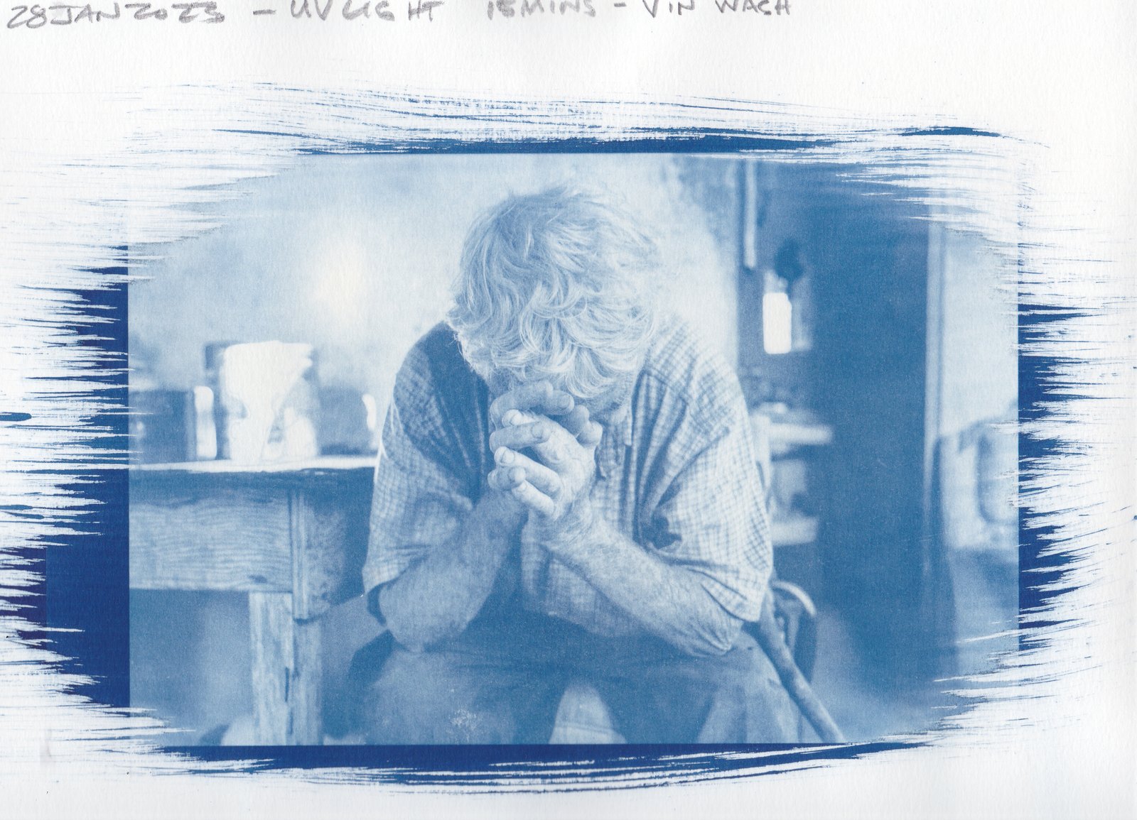 Paper test — Reynaldo seated on couch with Virgen de Guadalupe pillow, vinegar-toned cyanotype on paper, 15min UV exposure, 28 Jan 2023